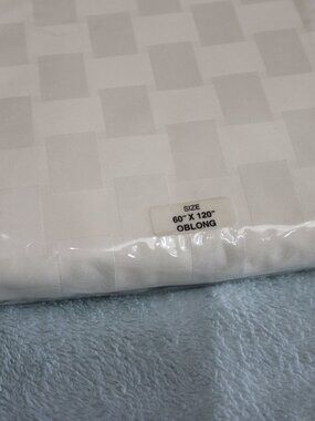 Reflections Microfiber cream checkered tablecloth. New. 60x120.